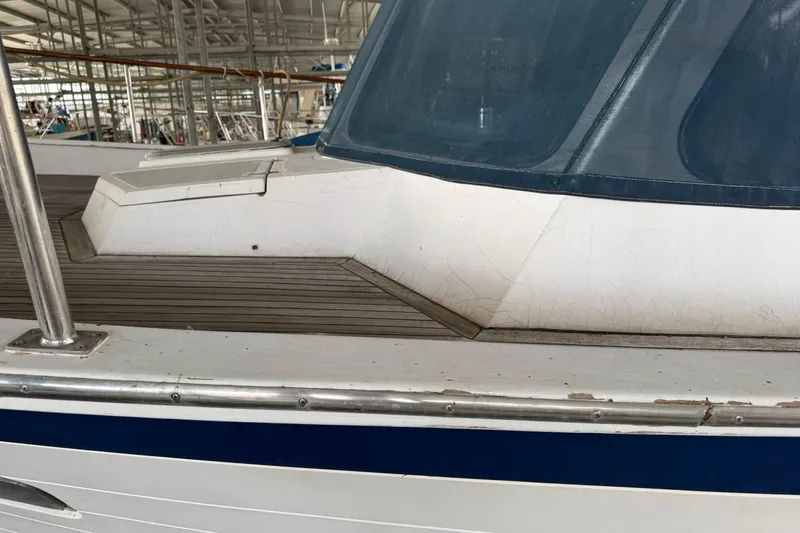 Sandial Yacht Photos Pics 1991 DeFever 44 yacht deck with wooden flooring and blue-tinted windows.