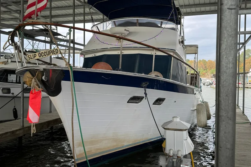 Sandial Yacht Photos Pics 1991 DeFever 44 yacht docked, displaying "Slip Occupied" sign, under covered marina.