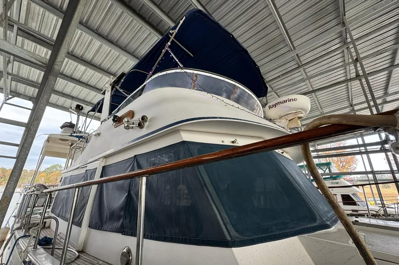 Sandial Yacht Photos Pics 1991 DeFever 44 yacht docked under a metal canopy, featuring Raymarine equipment.
