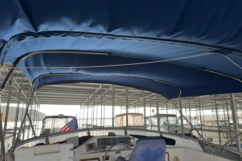 Sandial Yacht Photos Pics 1991 DeFever 44 yacht with blue canopy in marina setting.