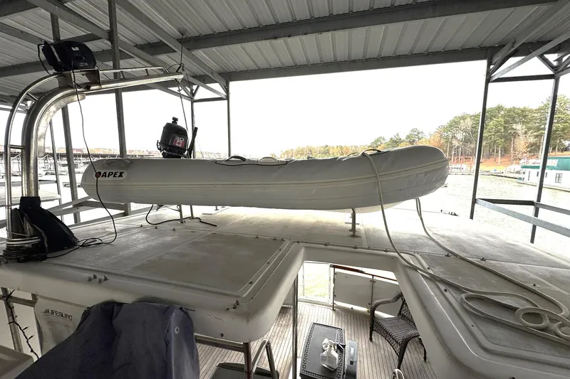 Sandial Yacht Photos Pics 1991 DeFever 44 yacht with Apex inflatable boat on deck, docked under shelter.