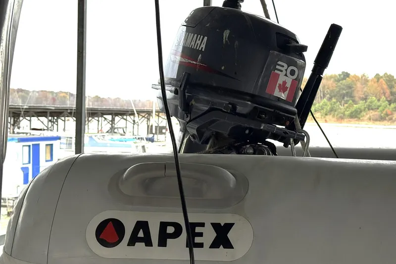 Sandial Yacht Photos Pics Apex inflatable boat with Yamaha 30 outboard motor, docked near a marina.