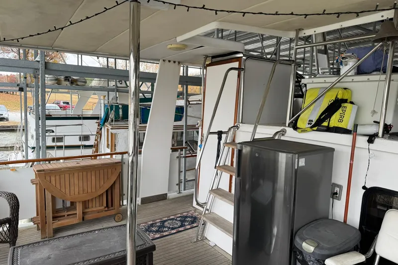 Sandial Yacht Photos Pics 1991 DeFever 44 yacht interior with wooden furniture, fridge, and safety equipment.