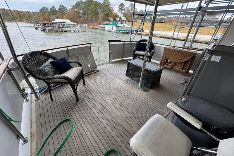 Sandial Yacht Photos Pics Spacious deck of 1991 DeFever 44 yacht with wicker seating and scenic marina view.