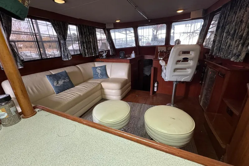 Sandial Yacht Photos Pics Luxurious 1991 DeFever 44 yacht interior with plush seating and nautical decor.