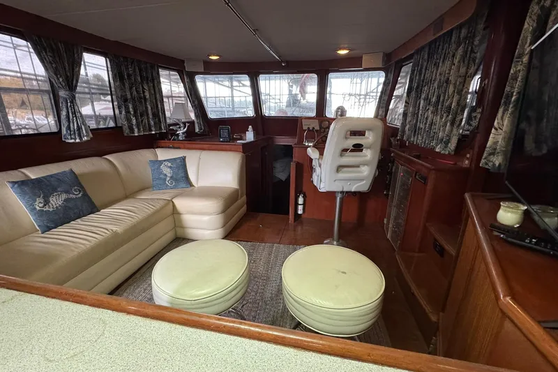 Sandial Yacht Photos Pics Luxurious interior of a 1991 DeFever 44 yacht with plush seating and nautical decor.