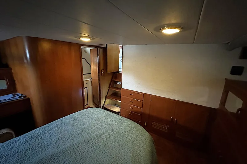 Sandial Yacht Photos Pics 1991 DeFever 44 yacht interior cabin with wood paneling and cozy lighting.