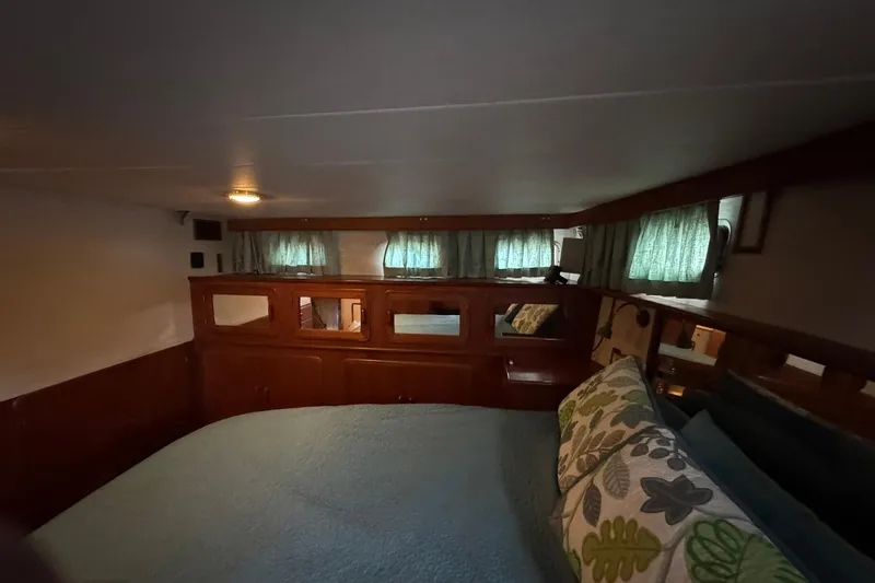 Sandial Yacht Photos Pics Cozy cabin interior of 1991 DeFever 44 yacht with wooden accents and green curtains.