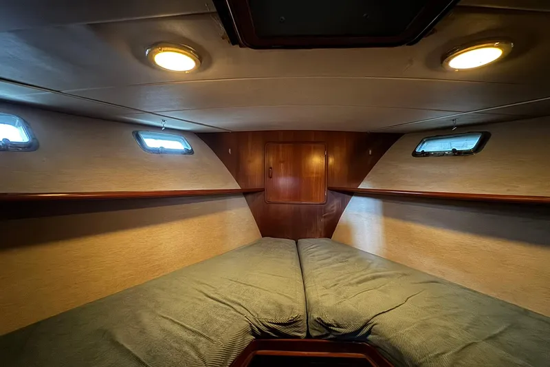 Sandial Yacht Photos Pics Cozy cabin interior of 1991 DeFever 44 yacht with twin beds and wooden accents.