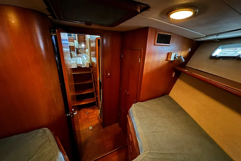 Sandial Yacht Photos Pics 1991 DeFever 44 yacht interior with wooden paneling and cozy sleeping area.