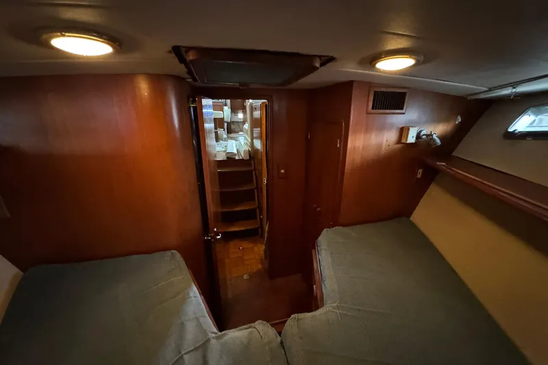 Sandial Yacht Photos Pics 1991 DeFever 44 yacht interior cabin with twin beds and wooden finish.