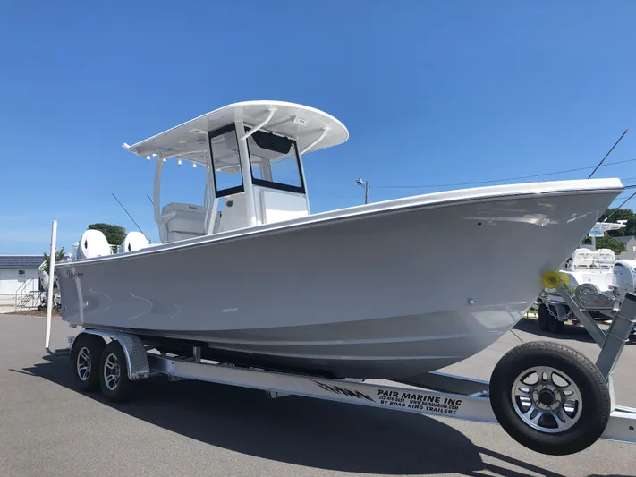  Yacht Photos Pics 2026 Pair Customs 24 Center Console DV boat on trailer under clear blue sky.