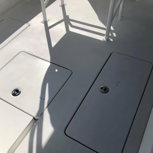  Yacht Photos Pics 2026 Pair Customs 24 Center Console DV boat deck with storage compartments.