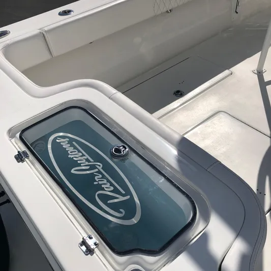  Yacht Photos Pics 2026 Pair Customs 24 Center Console DV boat interior with branded storage compartment.