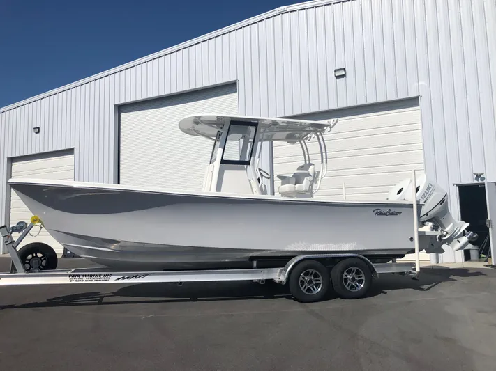  Yacht Photos Pics 2026 Pair Customs 24 Center Console DV boat on trailer outside a warehouse.