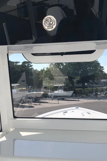  Yacht Photos Pics 2026 Pair Customs 24 Center Console DV boat, docked with other boats in the background.