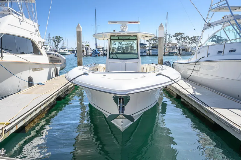 Nothing But Net Yacht Photos Pics 2016 Boston Whaler 350 Outrage docked between two boats.