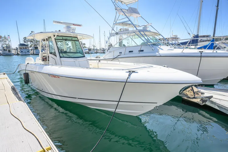 Nothing But Net Yacht Photos Pics 2016 Boston Whaler 350 Outrage boat docked in harbor.