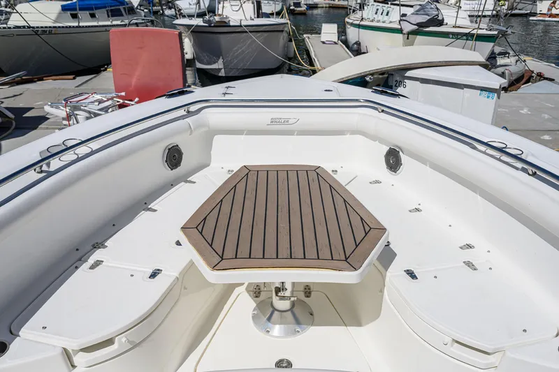 Nothing But Net Yacht Photos Pics 2016 Boston Whaler 350 Outrage with wooden table in bow area.