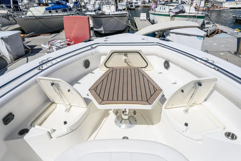 Nothing But Net Yacht Photos Pics 2016 Boston Whaler 350 Outrage with spacious deck and wooden table.