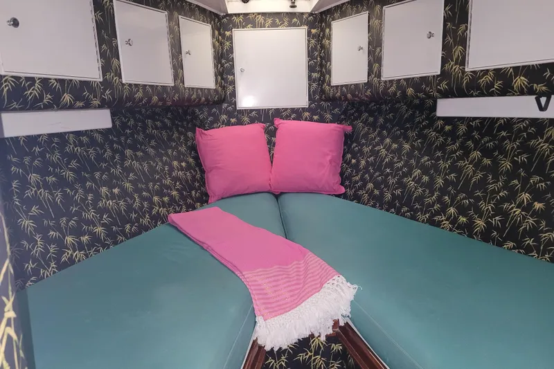  Yacht Photos Pics Cozy cabin interior of 1984 Sunny Briggs 37 Express with vibrant decor and storage cabinets.