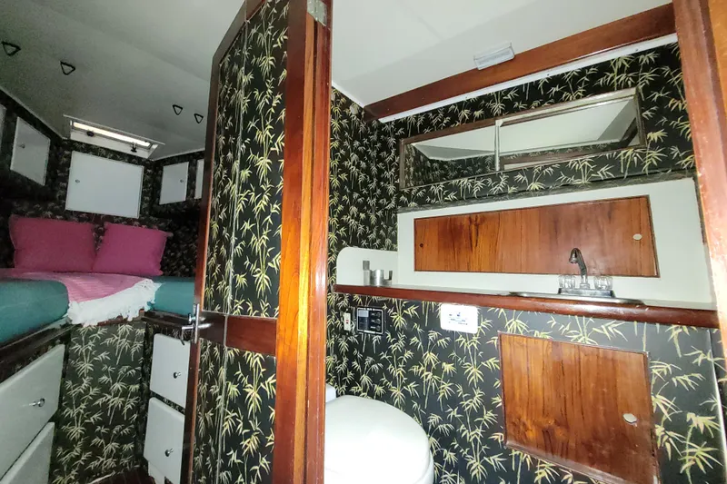  Yacht Photos Pics 1984 Sunny Briggs 37 Express cabin interior with floral wallpaper and wooden accents.
