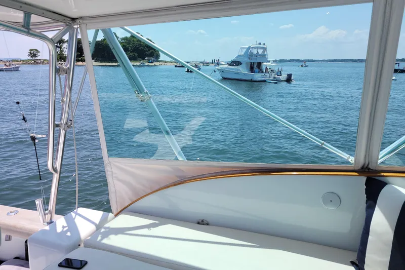  Yacht Photos Pics 1984 Sunny Briggs 37 Express yacht on serene water with scenic island view.