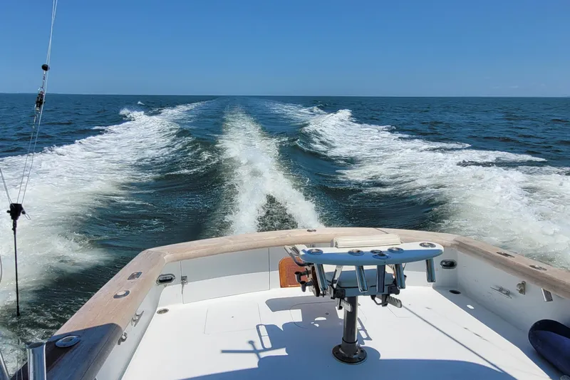  Yacht Photos Pics Sunny Briggs 37 Express boat cruising on open sea, leaving a foamy wake behind.