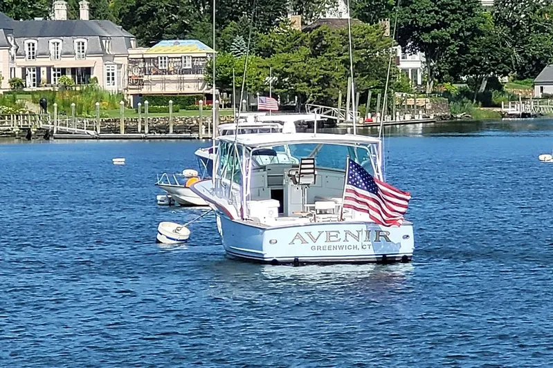  Yacht Photos Pics Sunny Briggs 37 Express boat, "Avenir," moored in Greenwich, CT, with American flag.