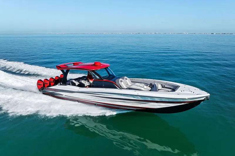  Yacht Photos Pics 2024 MTI V42 speedboat cruising on clear blue water, showcasing sleek design and powerful engines.