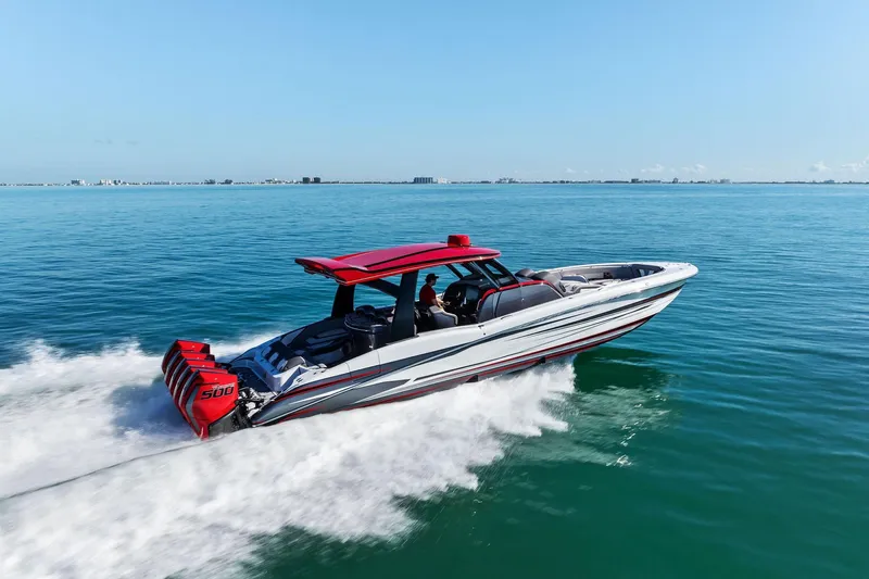  Yacht Photos Pics 2024 MTI V42 speedboat cruising on open water with red accents and powerful engines.