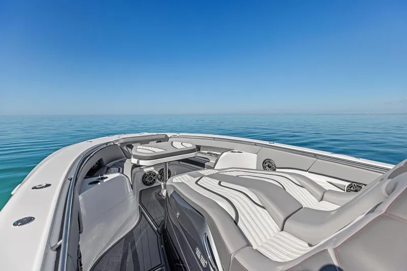  Yacht Photos Pics Luxurious 2024 MTI V42 boat interior with sleek seating on calm ocean waters.