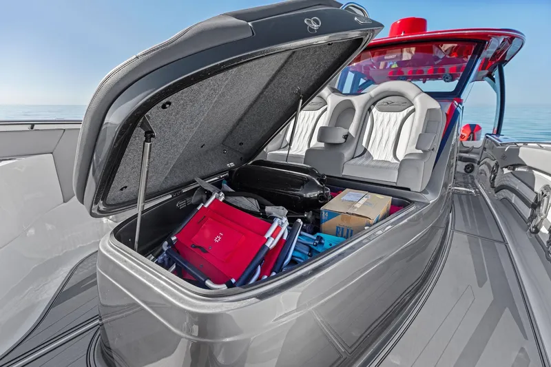  Yacht Photos Pics 2024 MTI V42 boat with open storage compartment, revealing packed items and seating area.