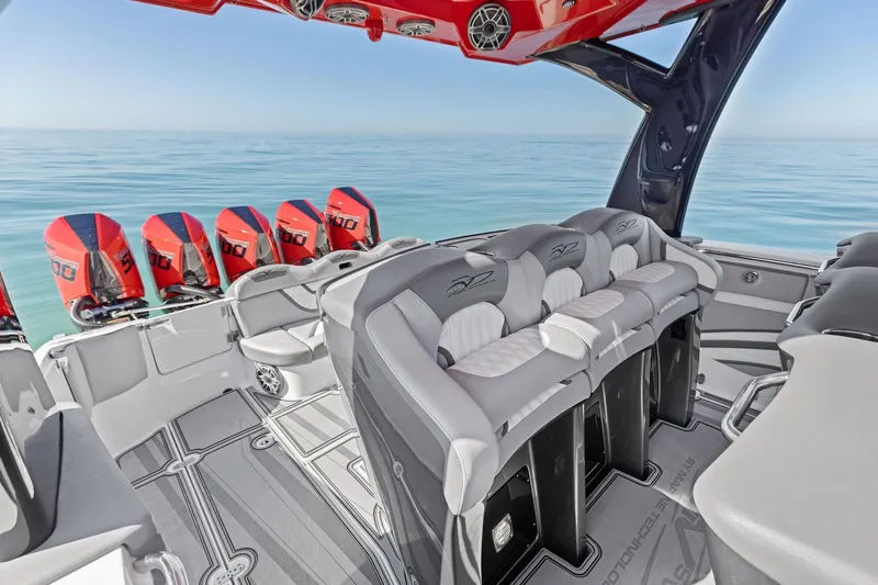  Yacht Photos Pics 2024 MTI V42 boat interior with red engines, luxurious seating, and ocean backdrop.