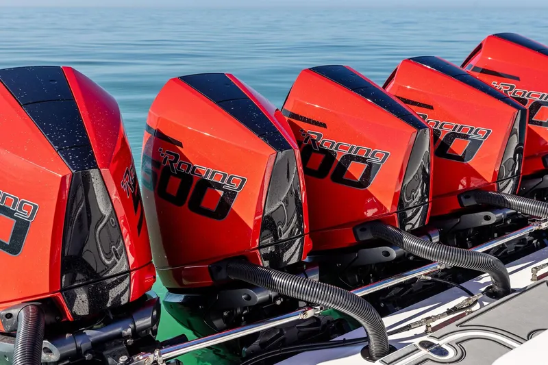  Yacht Photos Pics Red racing boat engines on MTI V42, 2024 model, lined up on calm water.
