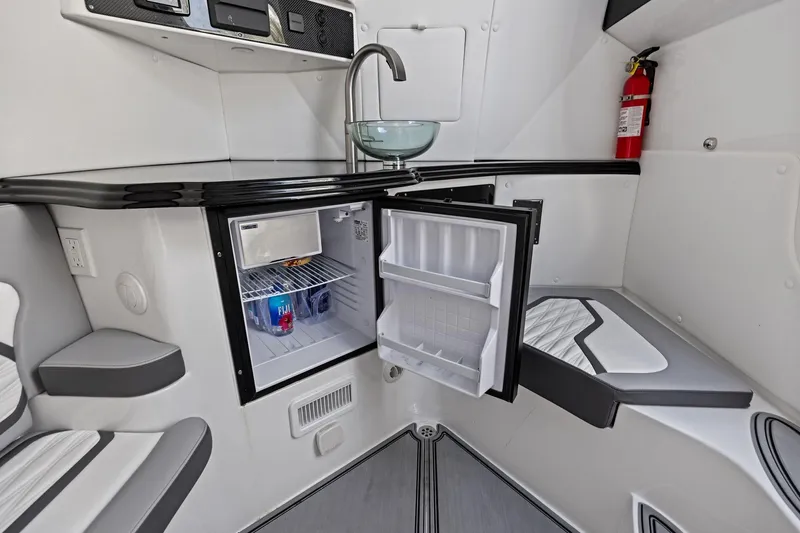  Yacht Photos Pics 2024 MTI V42 interior with open mini-fridge, modern sink, and fire extinguisher.