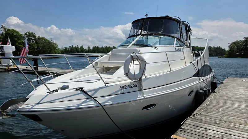  Yacht Photos Pics 2005 Carver 36 Mariner yacht docked on a sunny day, surrounded by water and trees.