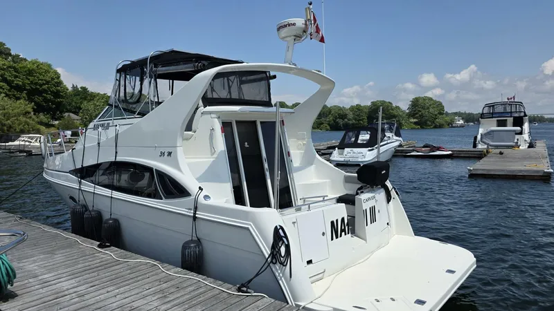  Yacht Photos Pics 2005 Carver 36 Mariner yacht docked at a marina on a sunny day.