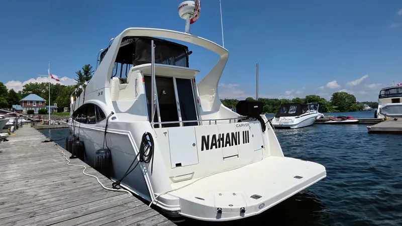  Yacht Photos Pics 2005 Carver 36 Mariner yacht docked at a marina on a sunny day.