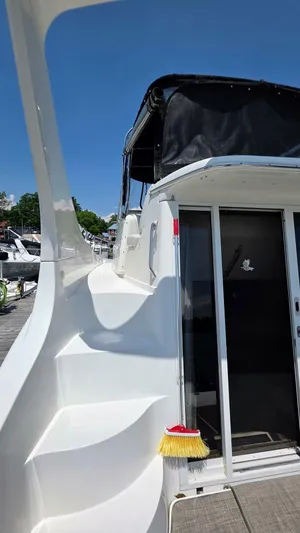  Yacht Photos Pics 2005 Carver 36 Mariner yacht with sleek white exterior and docked at marina.