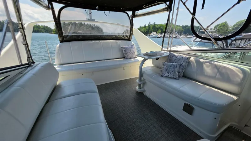  Yacht Photos Pics 2005 Carver 36 Mariner yacht interior with white seating, table, and scenic water view.