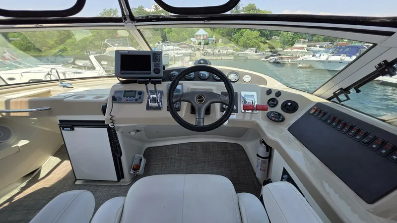  Yacht Photos Pics Helm of 2005 Carver 36 Mariner with steering wheel, controls, and navigation equipment.