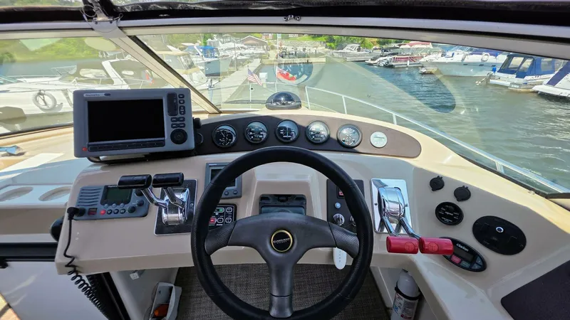  Yacht Photos Pics Helm of 2005 Carver 36 Mariner with navigation equipment and marina view.