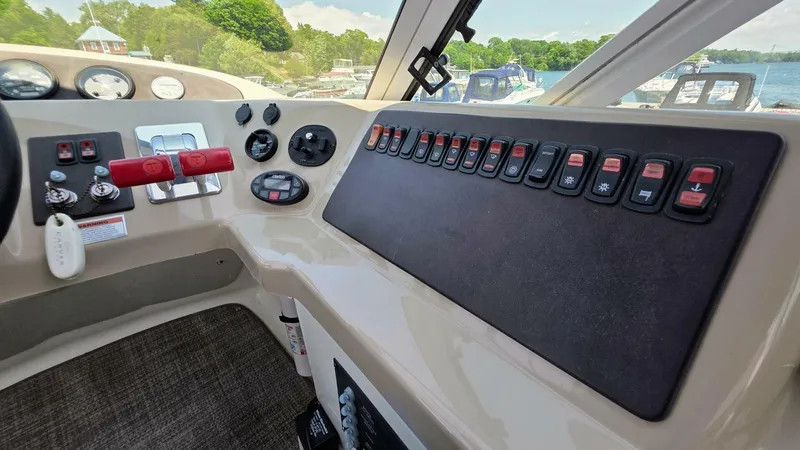  Yacht Photos Pics 2005 Carver 36 Mariner helm with control panel and switches, overlooking marina.