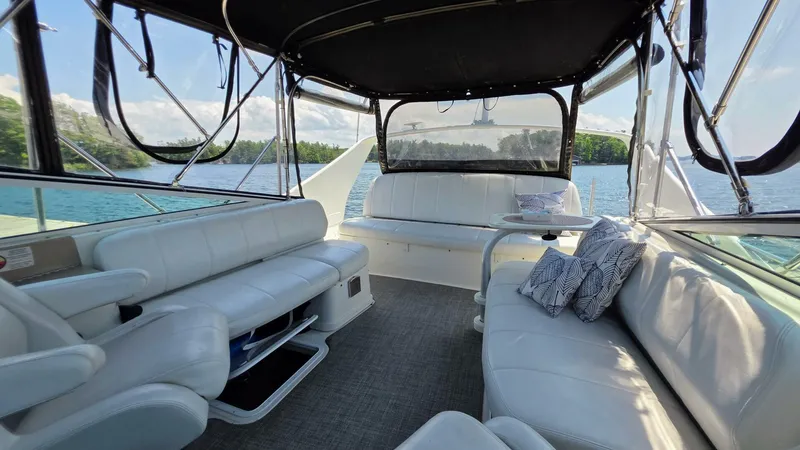  Yacht Photos Pics Interior of 2005 Carver 36 Mariner yacht with white seating and scenic water view.