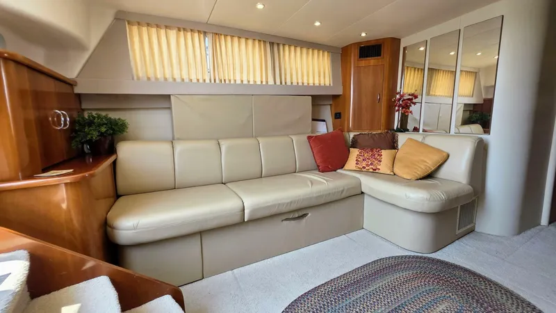  Yacht Photos Pics Luxurious interior of 2005 Carver 36 Mariner yacht with cream leather seating and decorative pillows.