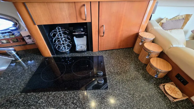  Yacht Photos Pics 2005 Carver 36 Mariner kitchen with stove, coffee maker, and storage containers.