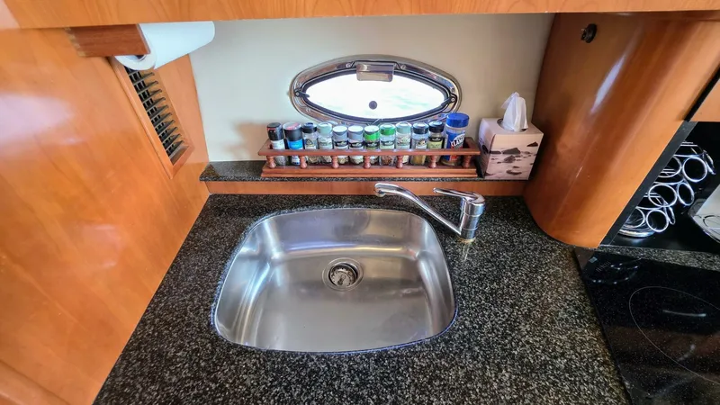  Yacht Photos Pics 2005 Carver 36 Mariner kitchen with sink, spices, and tissue box on granite countertop.
