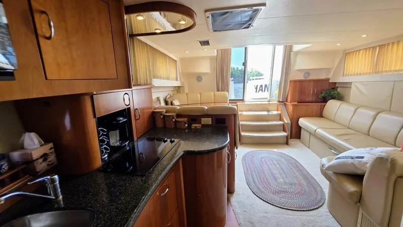  Yacht Photos Pics Luxurious interior of a 2005 Carver 36 Mariner yacht with modern kitchen and seating area.
