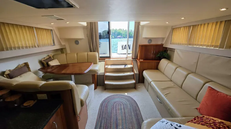  Yacht Photos Pics Luxurious interior of 2005 Carver 36 Mariner yacht with beige seating and wooden accents.